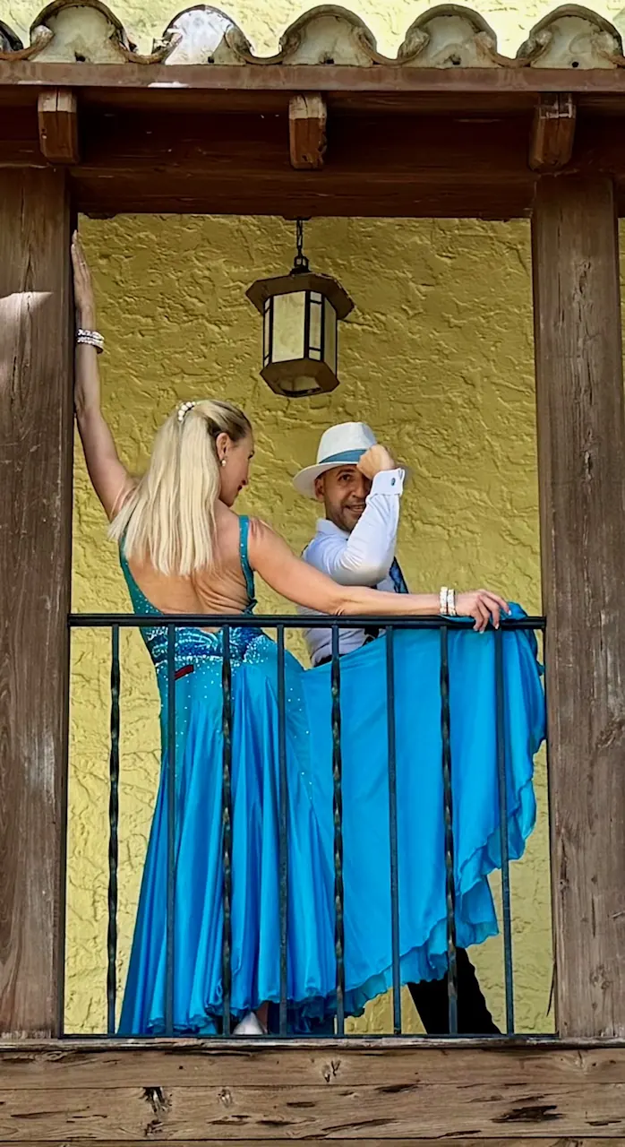 Ballroom dance couple performing on a balcony